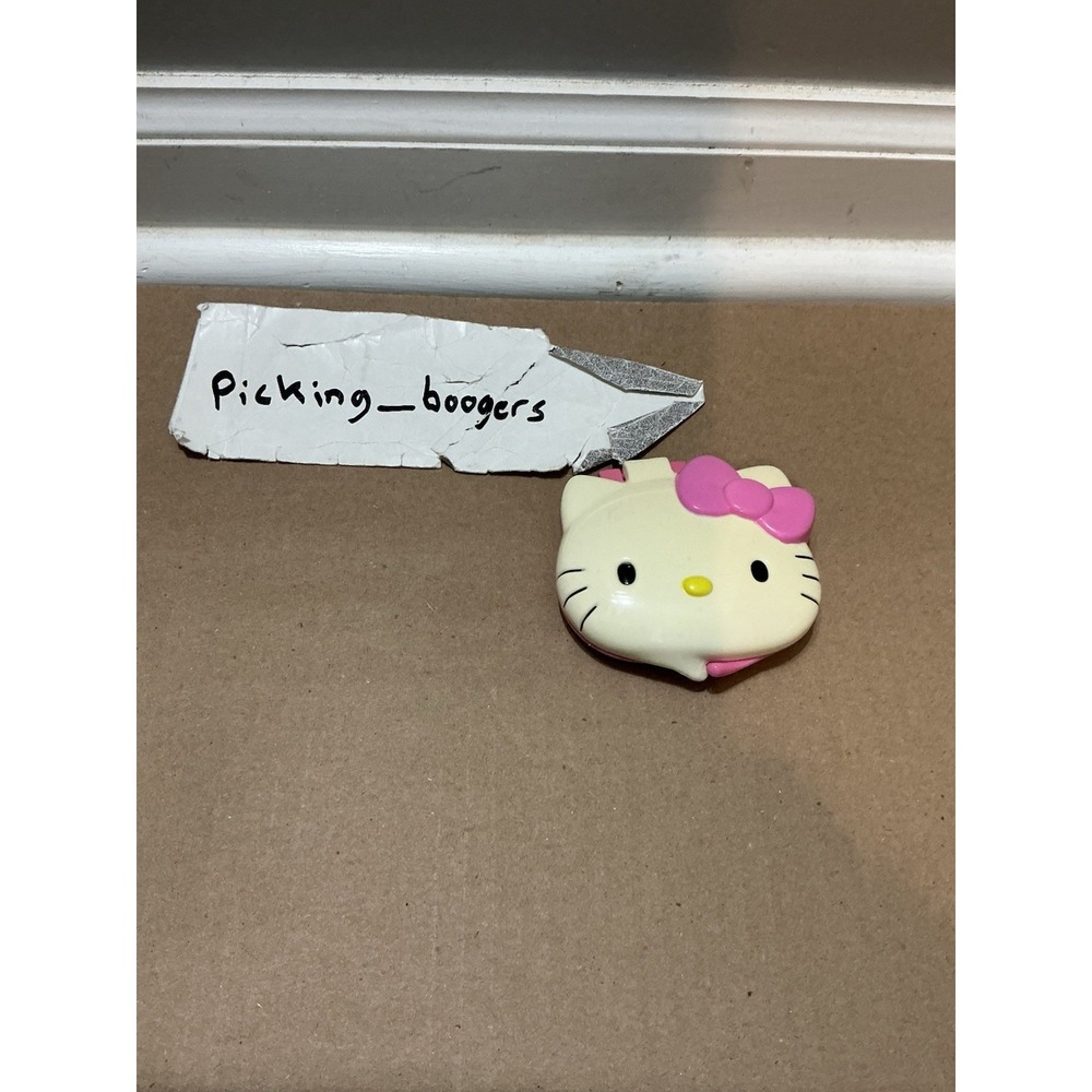 2007 McDonald's Hello Kitty face-shaped compact mirror and lip gloss toy